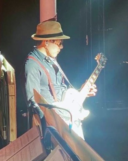 David Tran playing guitar on stage